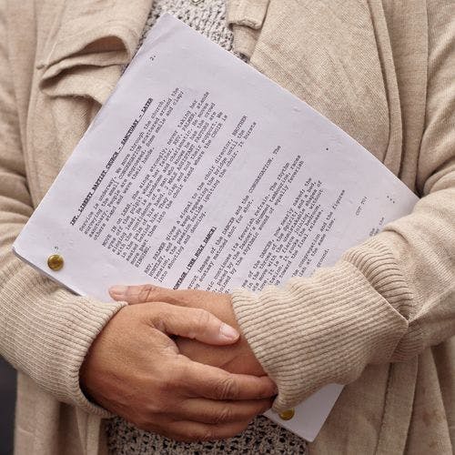 Person holding a script