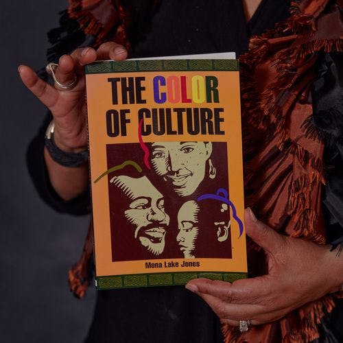 Person holding book The Color of Culture